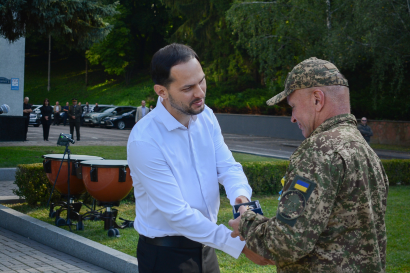 Начальник Рівненської ОВА Олександр Коваль вручає  військовому подарунковий годинник