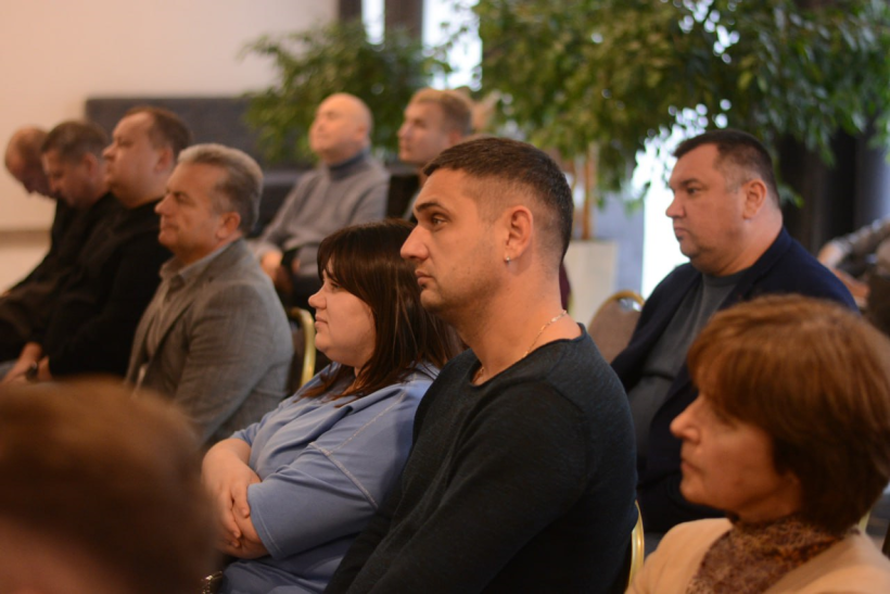 Учасники зустрічі сидять у залі та слухають спікера